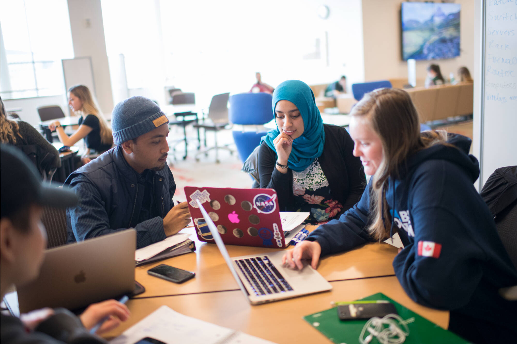 Group of students collaborating and using their laptops at the Mary Idema Pew Library